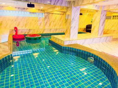 a large swimming pool with a red float in the middle at Orchid Pool Villa - SHA Extra Plus - indoor Warm pool in Phuket Town