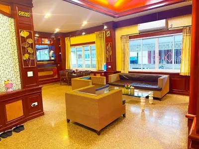 a living room with a couch and a table at Orchid Pool Villa - SHA Extra Plus - indoor Warm pool in Phuket Town