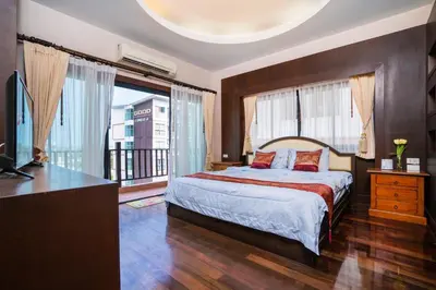 a bedroom with a bed and a large window at Orchid Pool Villa - SHA Extra Plus - indoor Warm pool in Phuket Town