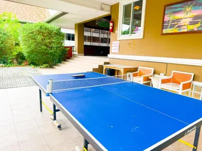 a blue ping pong table in a room with chairs at Orchid Pool Villa - SHA Extra Plus - indoor Warm pool in Phuket Town