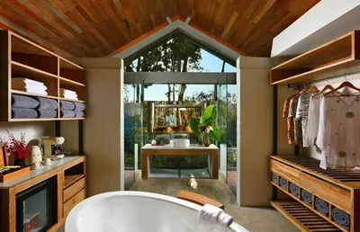 a bathroom with a tub and a large window at Villa Escape Burasari in Phuket Town