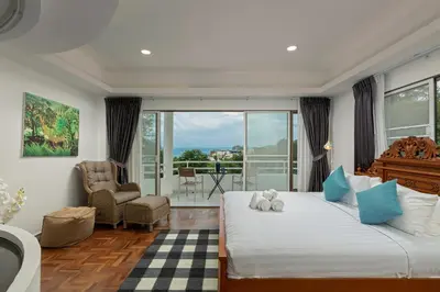 a bedroom with a bed with a teddy bear on it at 5BR Jungle Seaview Villa Patong in Patong Beach