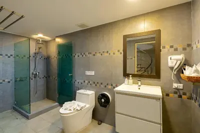 a bathroom with a shower and a toilet and a sink at 5BR Jungle Seaview Villa Patong in Patong Beach