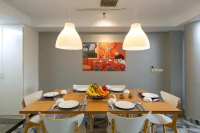 a dining room with a wooden table and chairs at 5BR Jungle Seaview Villa Patong in Patong Beach