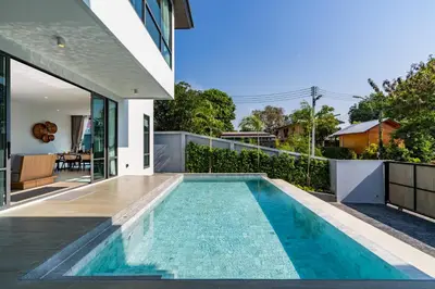 a swimming pool in the backyard of a house at Aya Residence Garden View in Ban Ket Ho