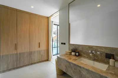 a bathroom with a large sink and a large mirror at Aya Residence Garden View in Ban Ket Ho
