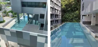a building with a swimming pool next to a building at Aya Residence Garden View in Ban Ket Ho