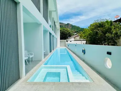 a swimming pool on the side of a building at Kata Place Villa in Kata Beach