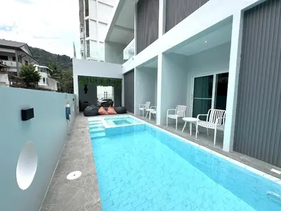 a swimming pool in the middle of a house at Kata Place Villa in Kata Beach