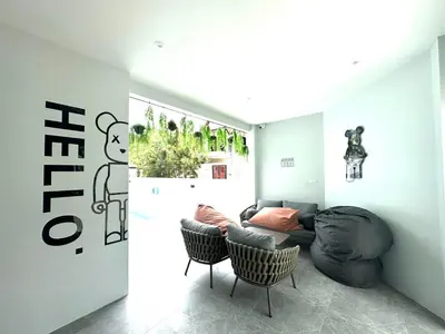 a living room with a couch and two chairs at Kata Place Villa in Kata Beach
