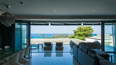 a living room with a view of the ocean at The Kata View Phuket apartment in Kata Beach