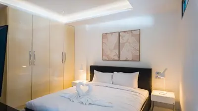 a bedroom with a bed with a towel animal on it at The Kata View Phuket apartment in Kata Beach