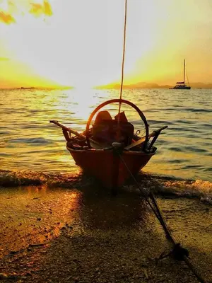 a boat sitting on the shore of a beach at Swiss Bonihouse Koh Yao Yai in Ban Phlu Nai