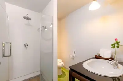 a bathroom with a sink and a shower and a toilet at THE TOP PATONG RESORT. in Patong Beach