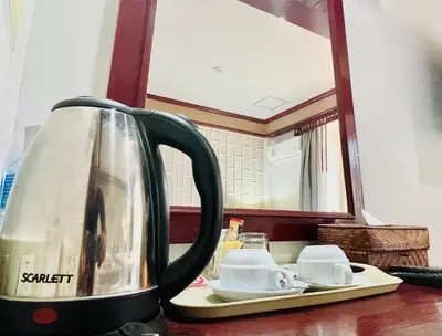 a tea kettle sitting on a counter in front of a mirror at THE TOP PATONG RESORT. in Patong Beach