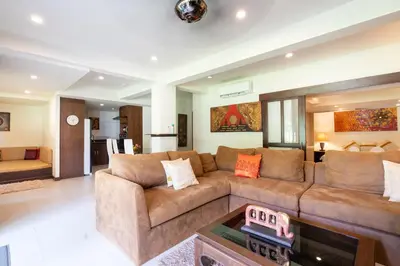 a living room with a couch and a table at Beachside Apt Short Walk to Nai Harn Beach 2-3 BR in Nai Harn Beach