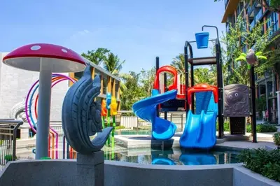 a water park with a playground with slides at The Panora apartments by NLA in Surin Beach