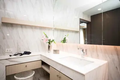 a bathroom with a sink and a mirror at The Panora apartments by NLA in Surin Beach