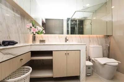 a bathroom with a sink and a toilet and a mirror at The Panora apartments by NLA in Surin Beach