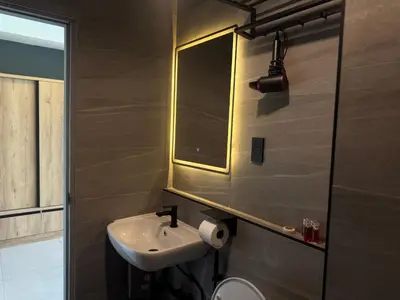 a bathroom with a sink and a mirror at Kefir Phuket in Kamala Beach
