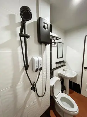a bathroom with a white toilet and a sink at Kefir Phuket in Kamala Beach