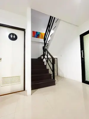 a staircase in a white room with a stair case at Kefir Phuket in Kamala Beach