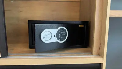 a microwave in a drawer with a remote control at Kefir Phuket in Kamala Beach