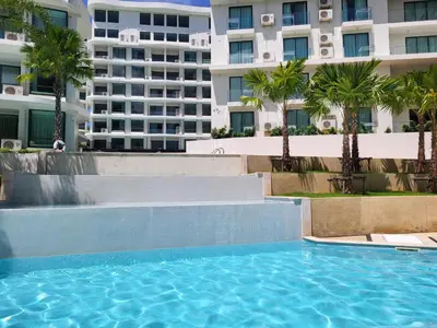 a swimming pool in front of a building at La Vita Phuket Rawai in Rawai Beach