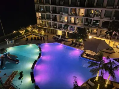 an overhead view of a large swimming pool at night at La Vita Phuket Rawai in Rawai Beach