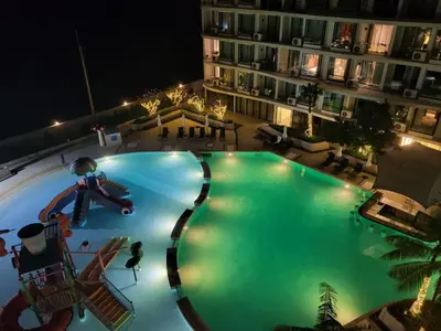 an overhead view of a large swimming pool at night at La Vita Phuket Rawai in Rawai Beach
