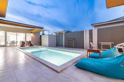 a house with a swimming pool and a patio at Andaman Sea Best Pool Access and Villas in Chalong