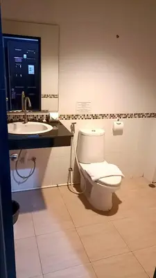 a bathroom with a toilet and a sink at New Lavender Hotel Patong in Patong Beach