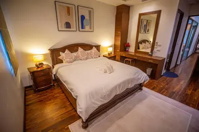 a bedroom with a large bed with white sheets at Phuket Boutique Pool Villa-81 in Rawai Beach