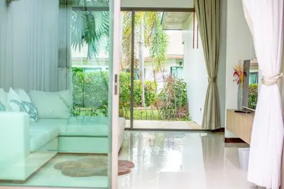 a living room with a couch and a large window at Phuket Boutique Pool Villa-81 in Rawai Beach