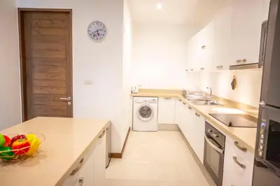 a white kitchen with a washing machine in it at Phuket Boutique Pool Villa-81 in Rawai Beach