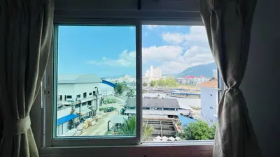 a large window with a view of a city at Jasmin Guest House in Patong Beach