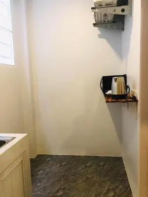 a kitchen with a sink and a shelf on the wall at M&N Guesthouse Kata in Kata Beach