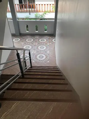 a staircase with a tile floor in a building at M&N Guesthouse Kata in Kata Beach