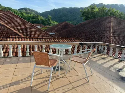 a table and two chairs sitting on a roof at Kathu Home with Mountain View in Kathu