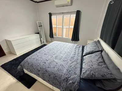 a bedroom with a large bed and a window at Kathu Home with Mountain View in Kathu