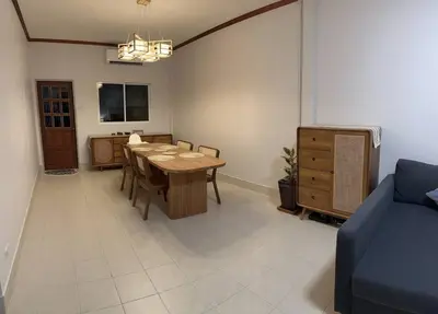 a dining room with a table and a blue couch at Kathu Home with Mountain View in Kathu
