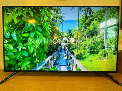 a television screen with a picture of a bridge at Brand Naithon Condo C411 in Nai Thon Beach