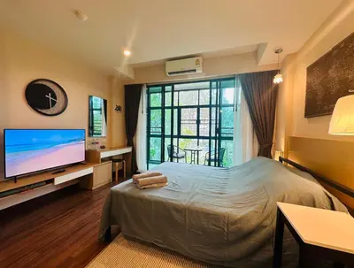 a bedroom with a bed and a flat screen tv at Brand Naithon Condo C411 in Nai Thon Beach
