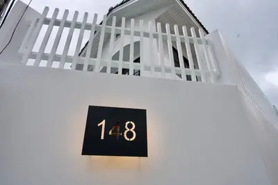 a building with a clock on the side of it at House 148 Patong Pool Villa 4BR Near Beach in Patong Beach