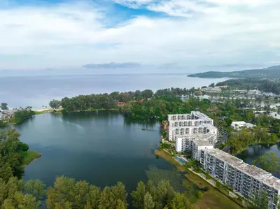 an aerial view of a building on a lake at Cassia Residences by NLA in Bang Tao Beach