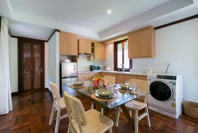 a kitchen with a table and chairs and a microwave at Katamanda 1Bedrooms Apartment near Kata Beach in Kata Beach