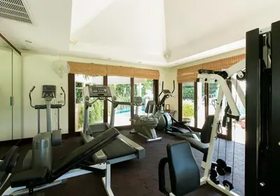 a gym with treadmills and ellipticals in a room at Katamanda 1Bedrooms Apartment near Kata Beach in Kata Beach