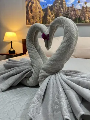 two swans made out of towels on a bed at S a f e Residence Patong in Patong Beach