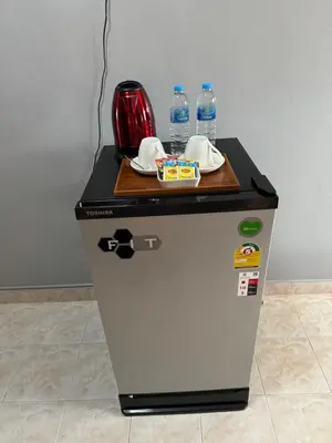 a small refrigerator with a table on top of it at S a f e Residence Patong in Patong Beach