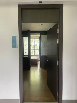 a hallway with a door leading to a living room at Apartment near Central phuket in Phuket Town